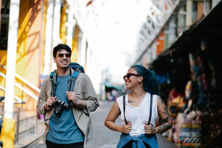 A cheerful couple with backpacks enjoying sightseeing during their travel adventure.
